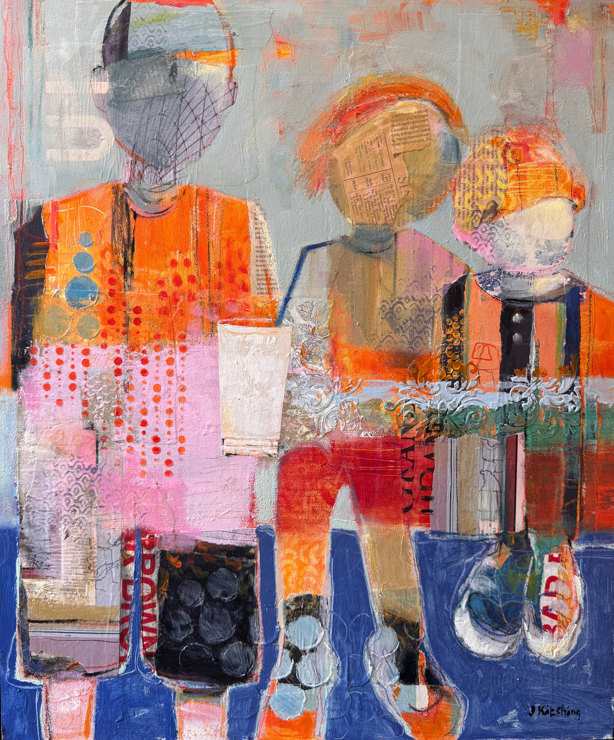 An abstract painting of three stylized figures in orange, pink, blue, black, and white, housed in a black frame and displayed on an easel.