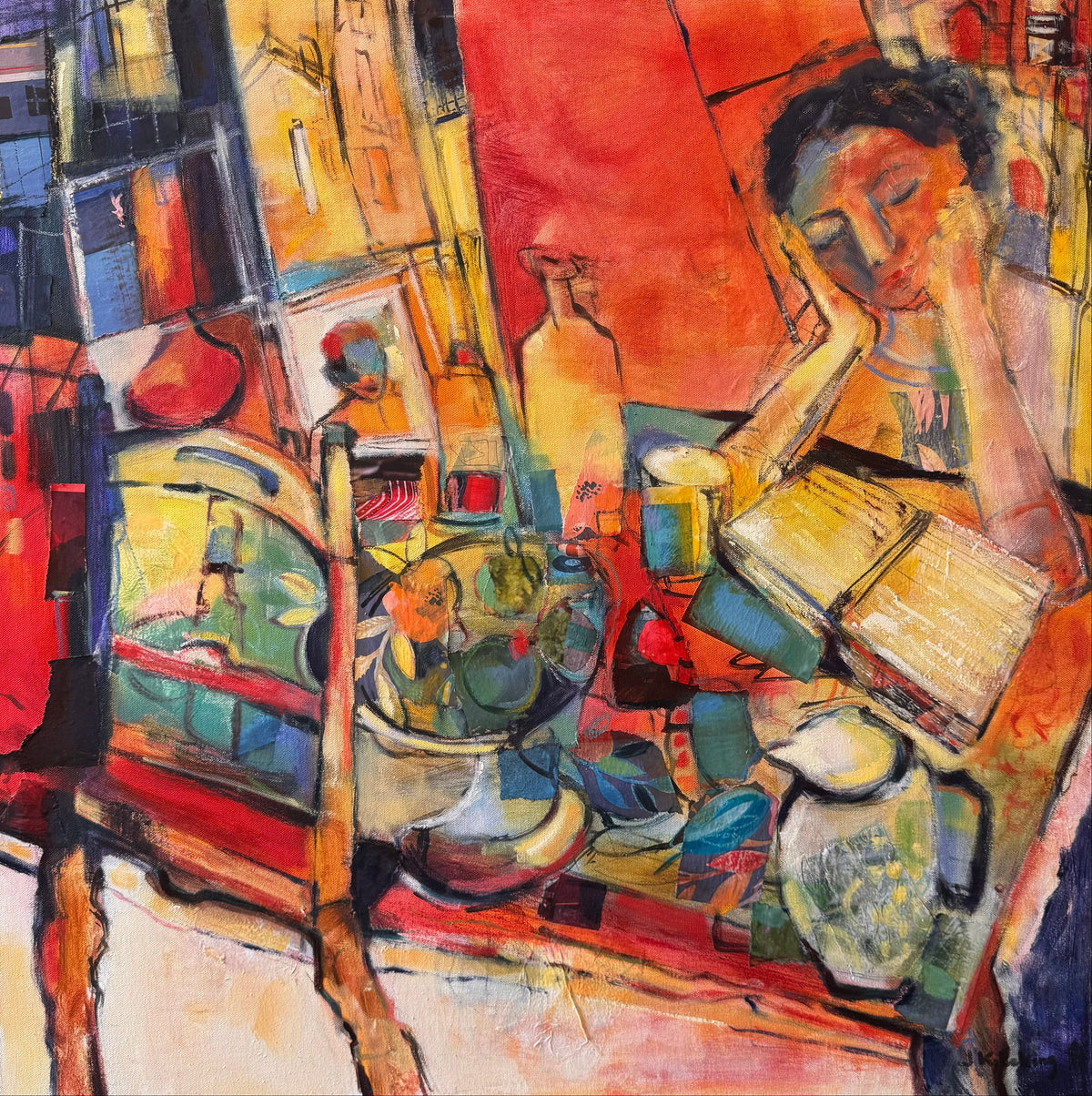 An abstract expressionist painting depicting a woman reading, rendered in a vibrant palette of red, orange, yellow, blue, and green, housed in a black frame.