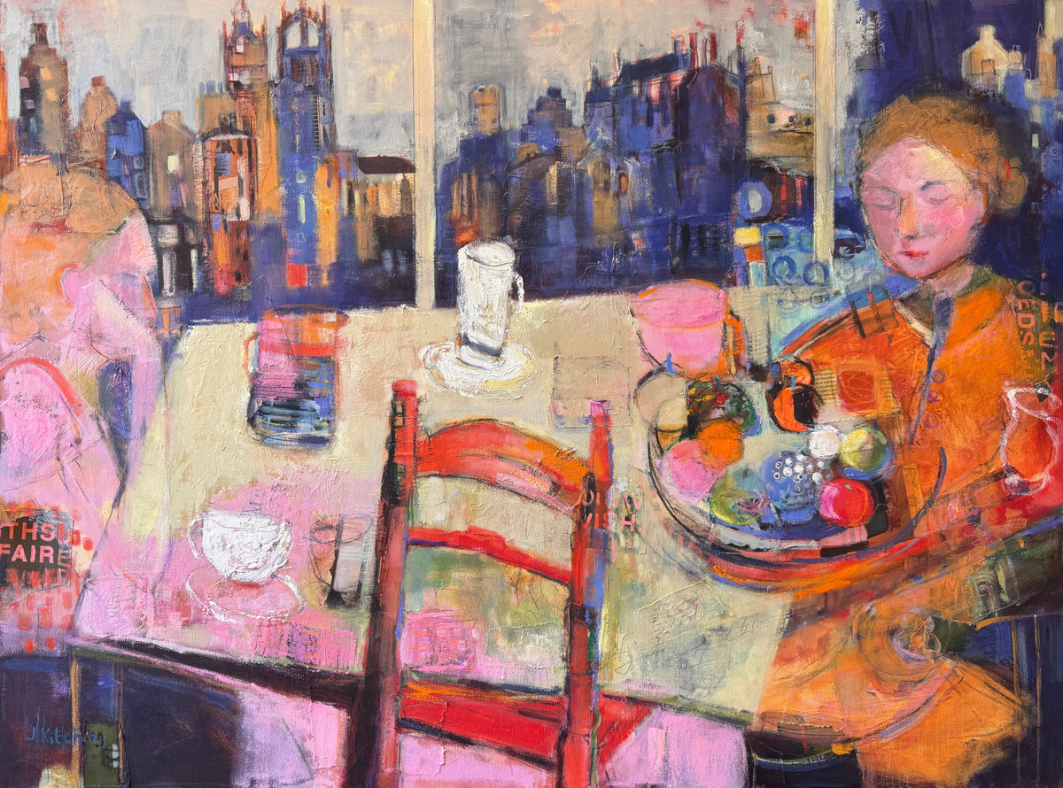 A framed painting depicting an artist at a table with a paint palette, set against a city skyline background, shown hanging on a wall.