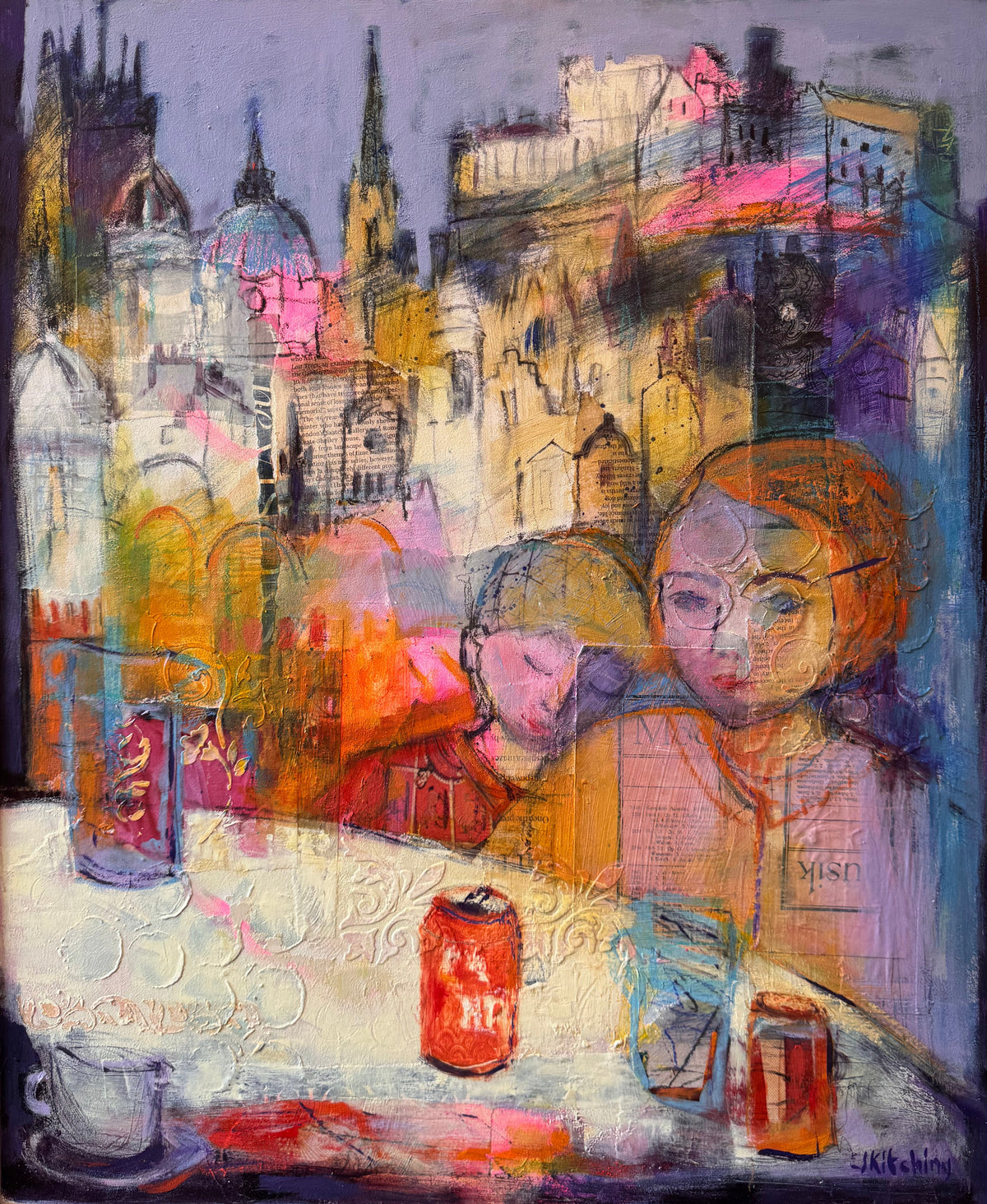 An expressive, colorful painting of two children at a table with drinks, set against a cityscape background with spires and buildings. The artwork is housed in a white frame and displayed on an easel.
