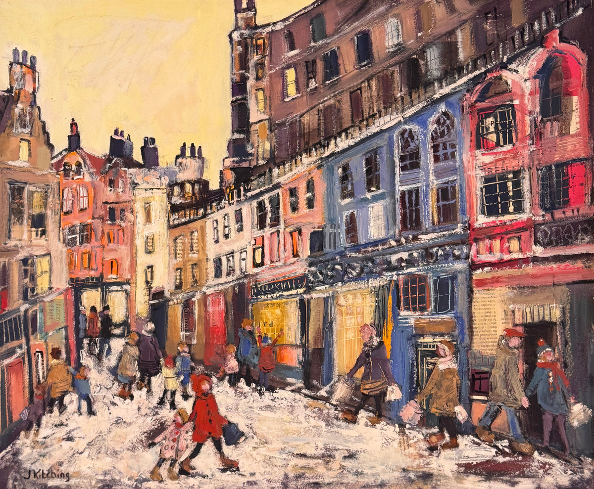 A framed painting of a snowy city street scene with colorful buildings and pedestrians, mounted on a beige wall.