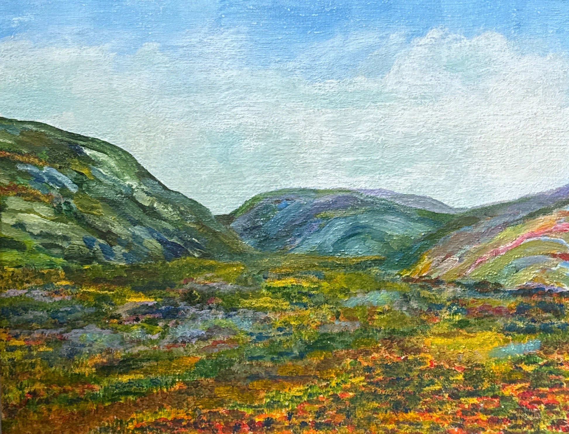 Framed painting of a landscape with a mountain and colorful foliage