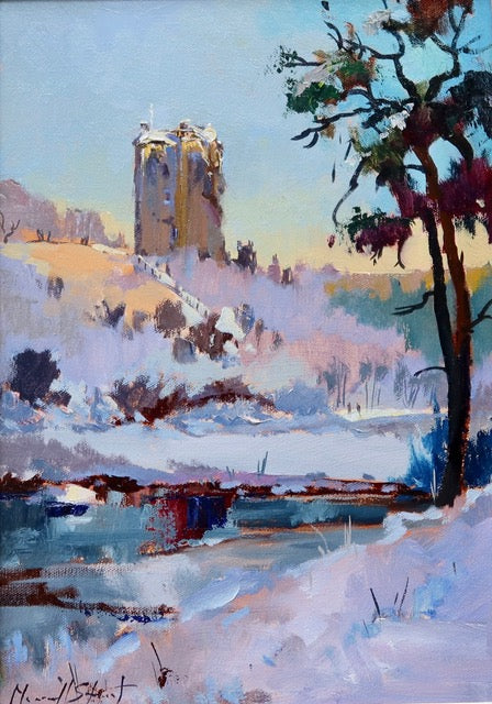 Winter landscape with a tall building, trees, and snow-covered ground.