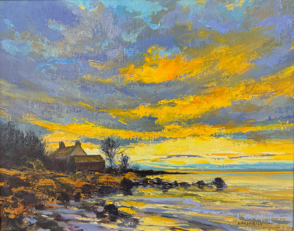 A framed landscape oil painting featuring a cottage by the sea under a dramatic yellow, orange, and blue sky, presented in a gold frame with a black mat.