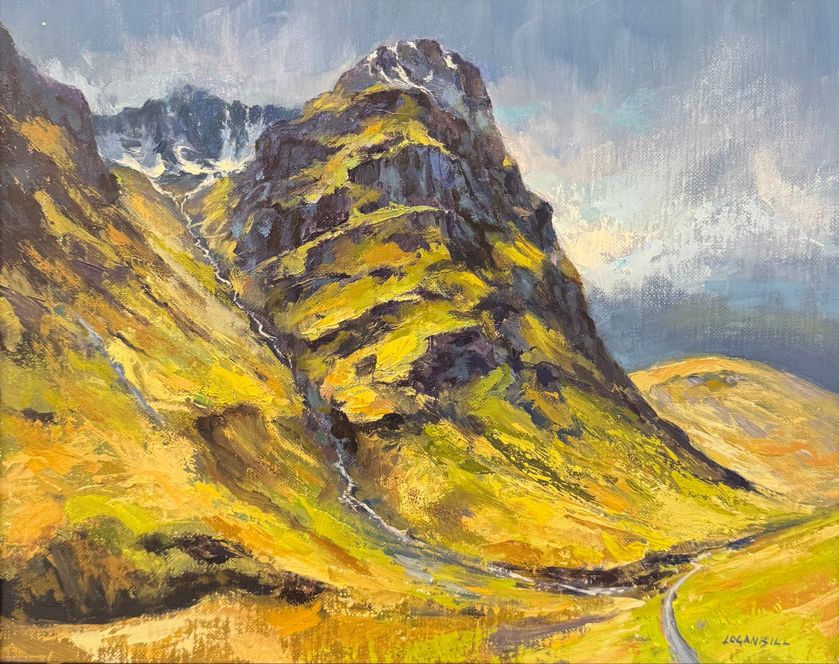 A framed landscape oil painting depicting a dramatic mountain peak with golden-yellow and green slopes, a winding road, and a cloudy blue sky. The painting is housed in a dark brown wooden frame.