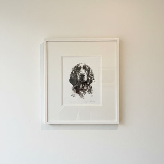 Framed artwork of a dog on a beige wall