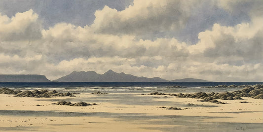 A watercolour of a beach scene with rocks and distant mountains under a cloudy sky