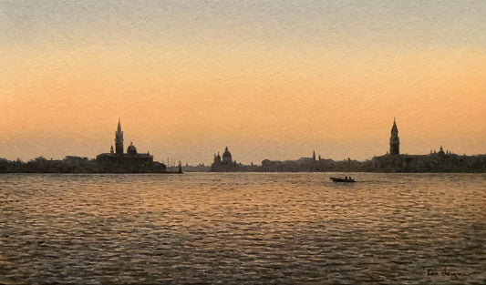 Venice cityscape with buildings and a boat on water during sunset.