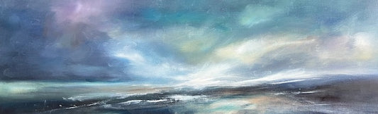 Panoramic view of a coastal landscape with a cloudy sky.