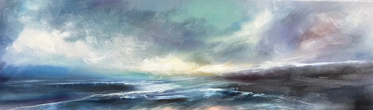 Panoramic view of a coastal landscape with clouds and water.