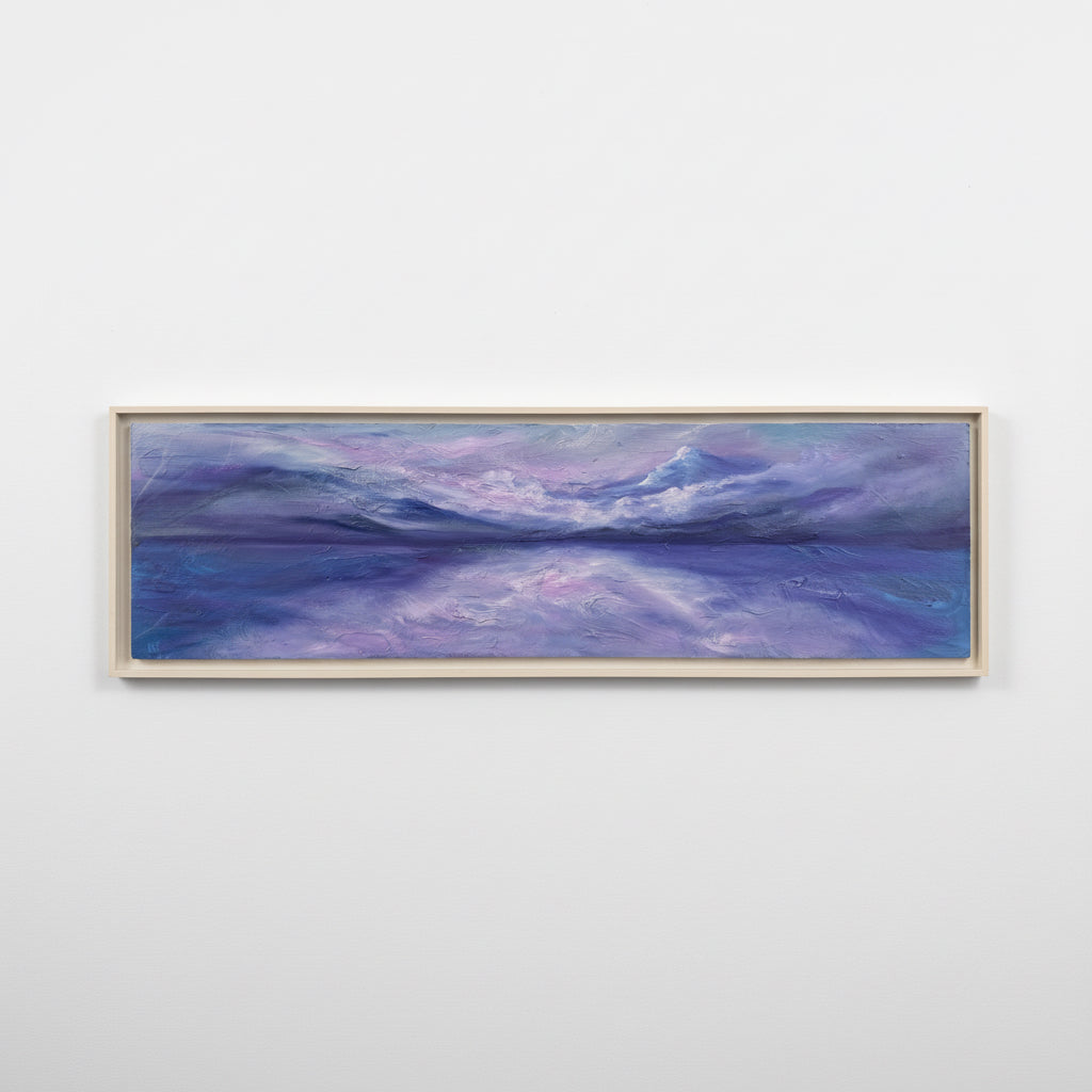 Framed artwork of a landscape with purple and blue hues on a white background