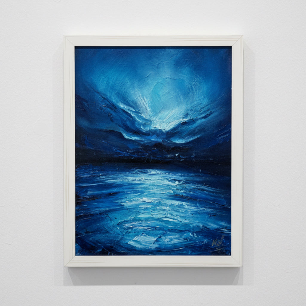 Framed abstract blue seascape painting on a white wall