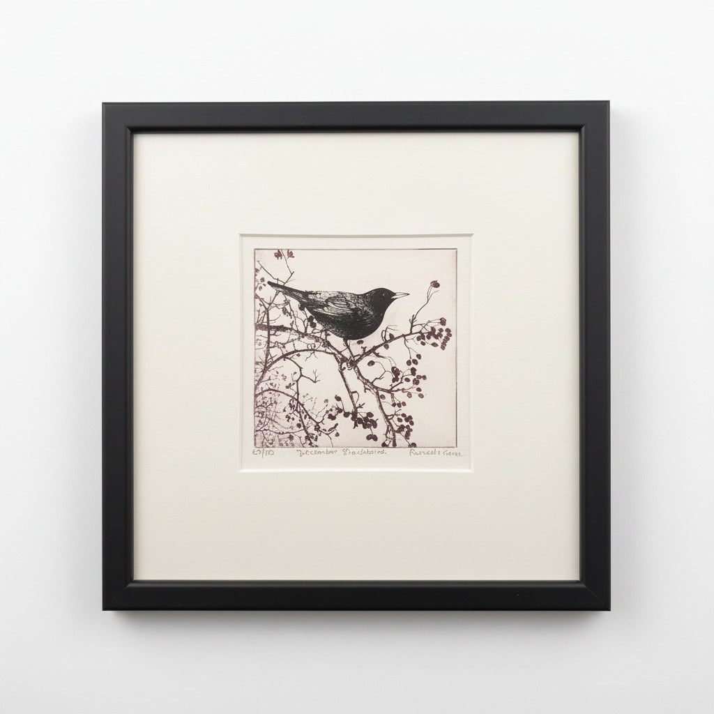 Framed artwork of a bird on a branch against a neutral background