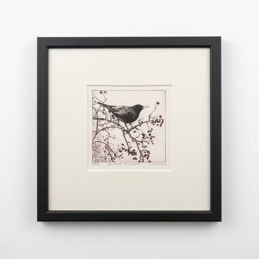 Framed artwork of a bird on a branch against a neutral background