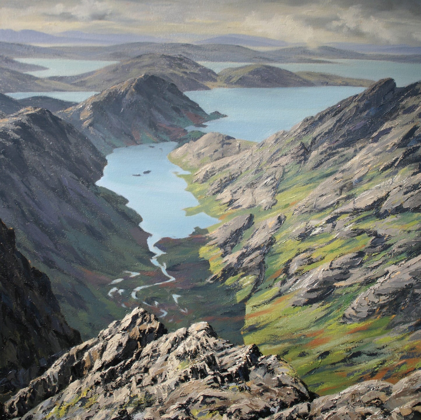 Scenic view of a mountainous landscape with lakes and rocky terrain.