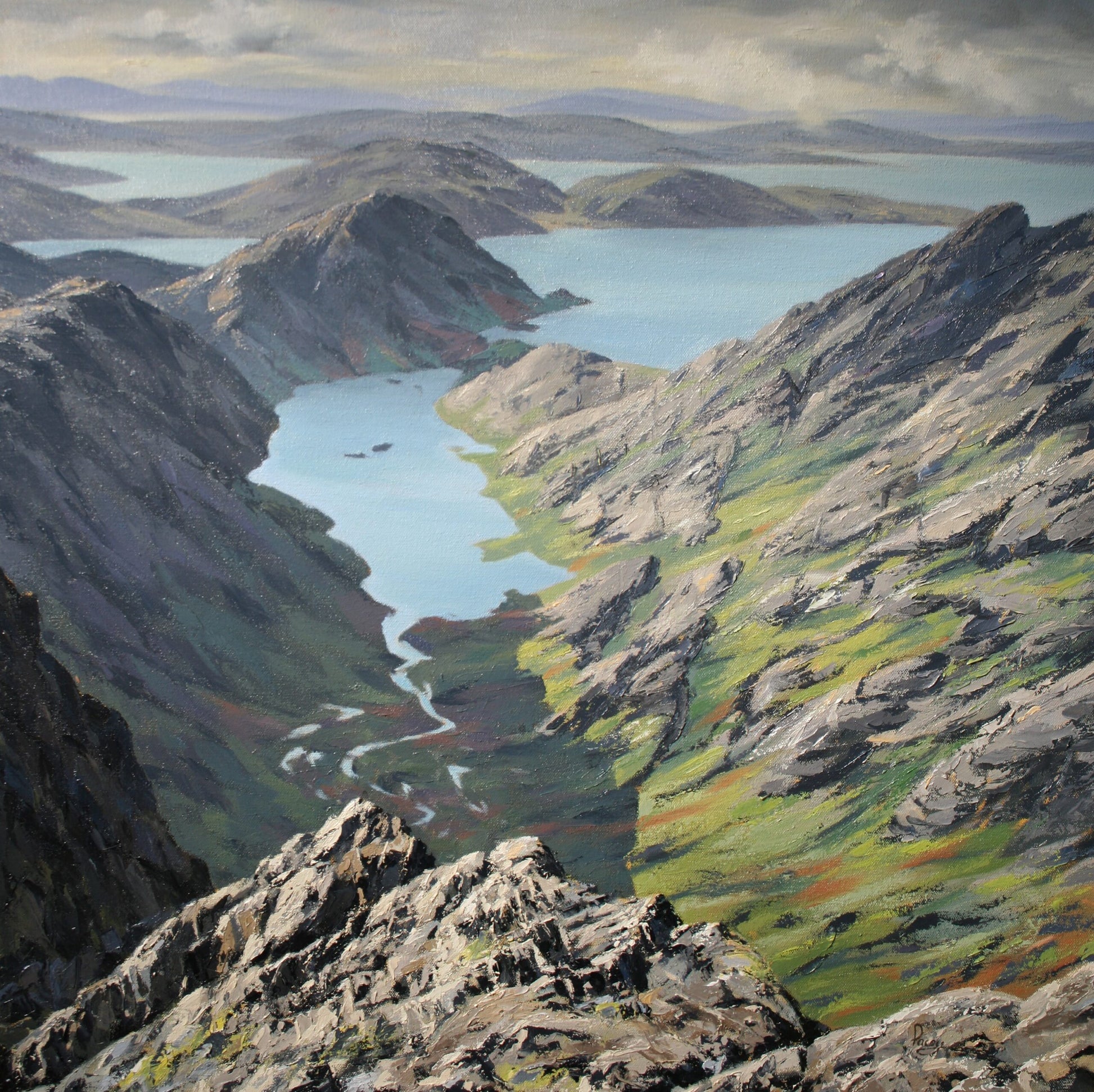 Scenic view of a mountainous landscape with lakes and rocky terrain.