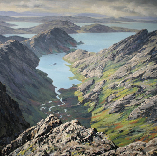Scenic view of a mountainous landscape with lakes and rocky terrain.