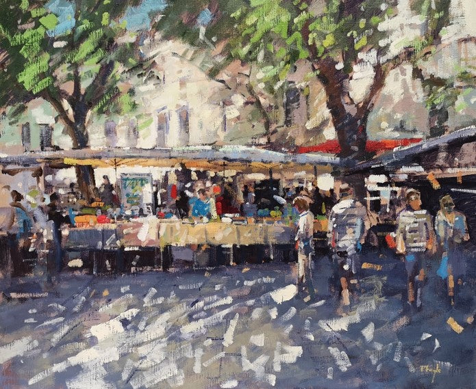 Outdoor market scene with people and tables under trees