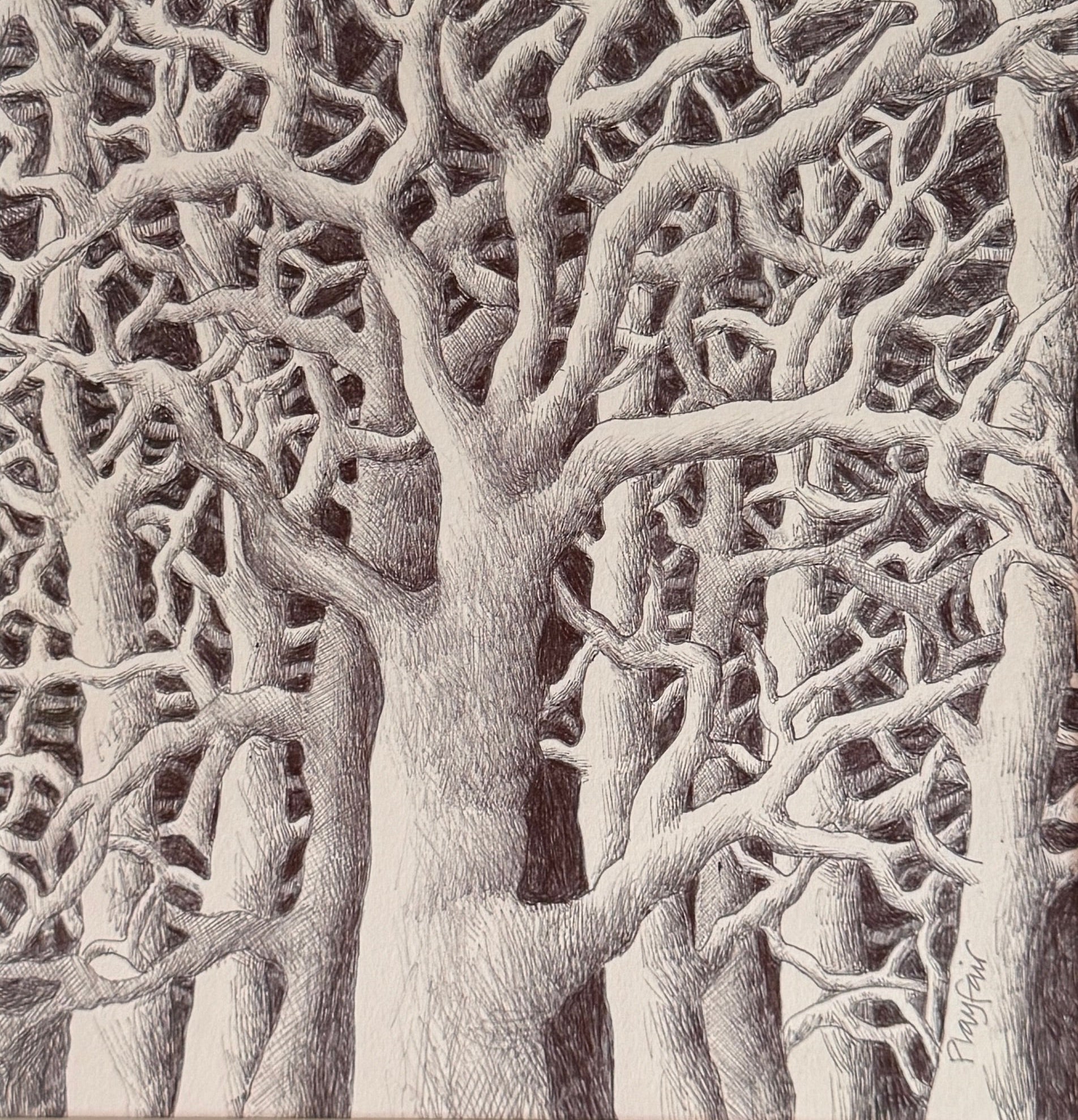 Framed black and white artwork of tree branches on a dark background