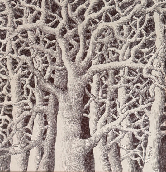 Framed black and white artwork of tree branches on a dark background