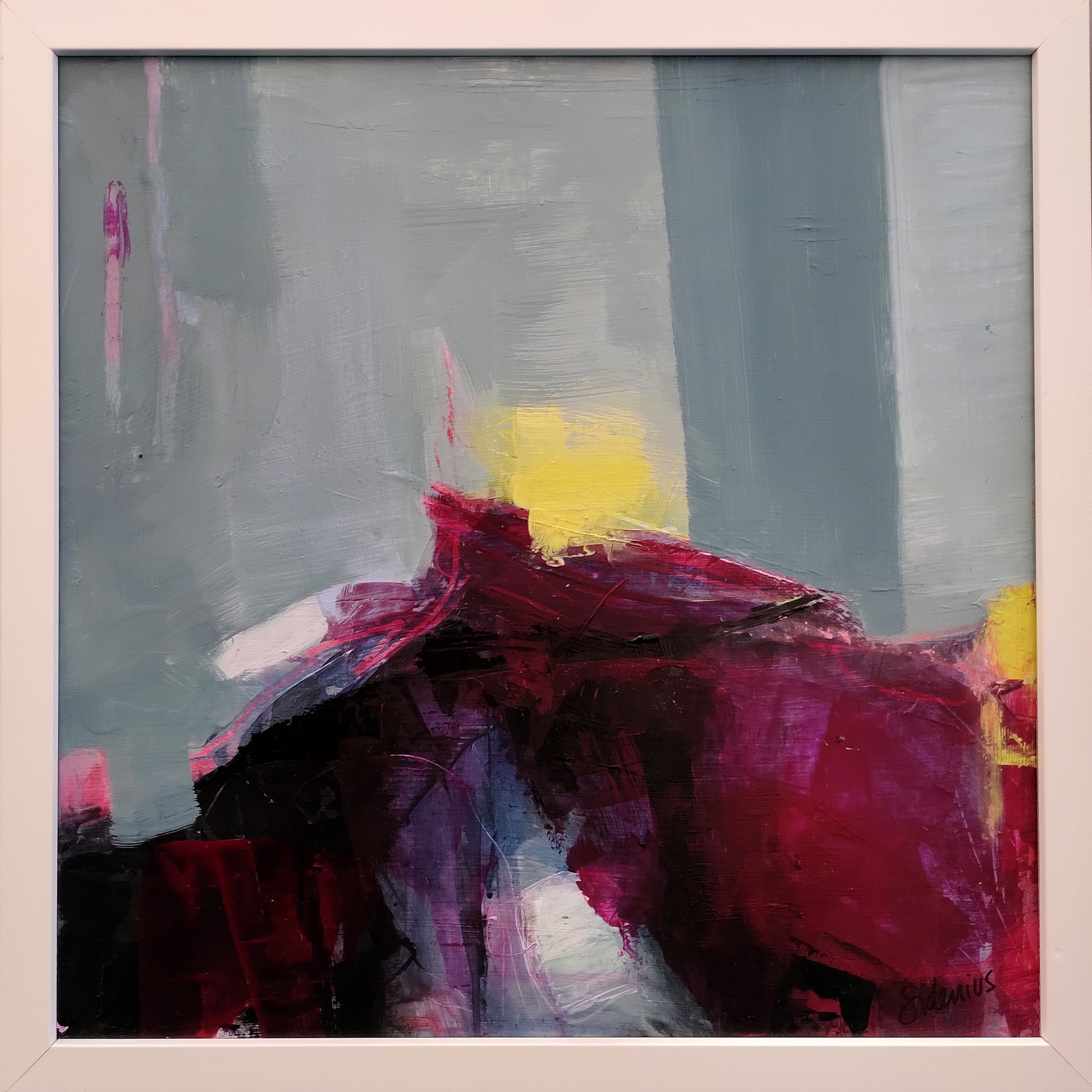 Abstract painting of Arthur's Seat in Edinburgh with red, yellow, and gray colors in a white frame.