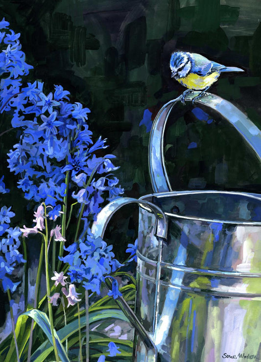 Blue tit bird perched on a silver watering can with blue flowers in the background