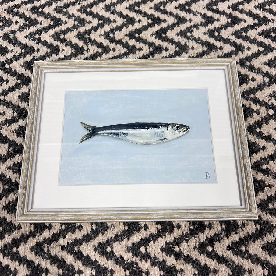 Framed artwork of a fish on a patterned surface