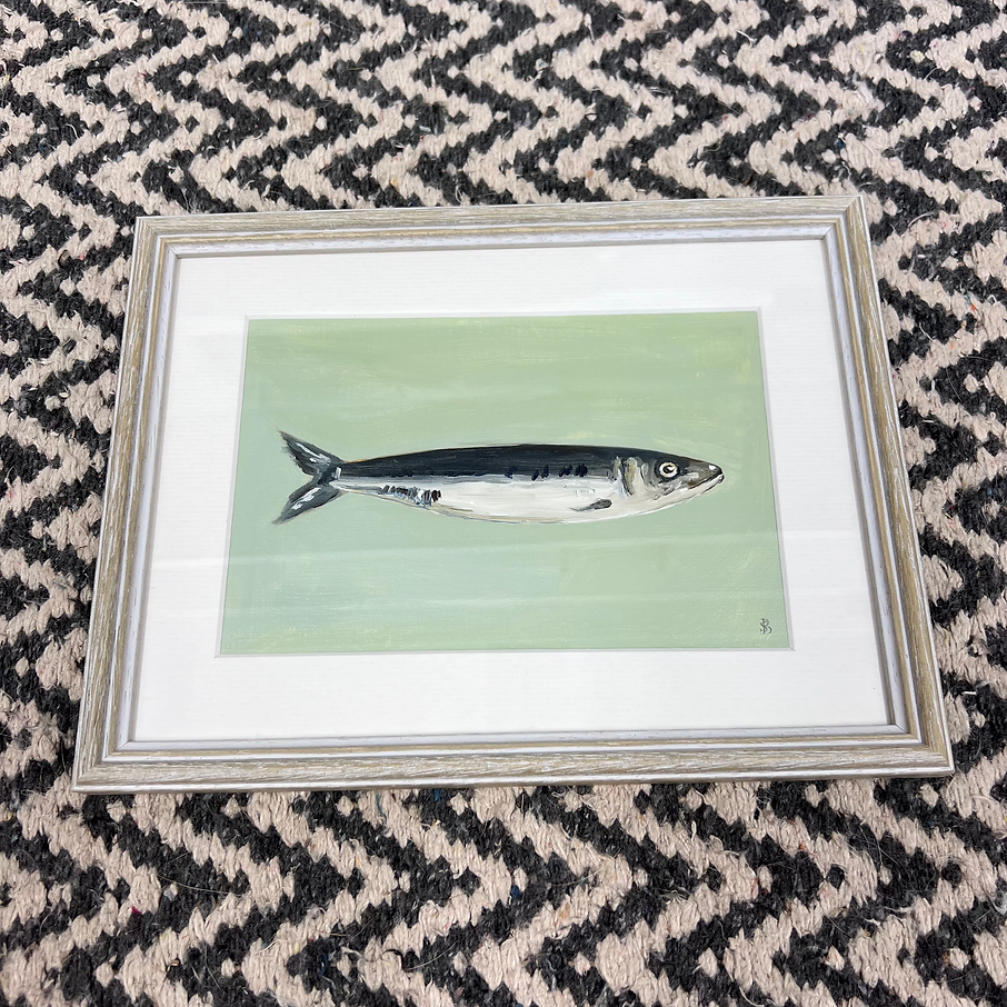 Framed artwork of a fish on a patterned surface