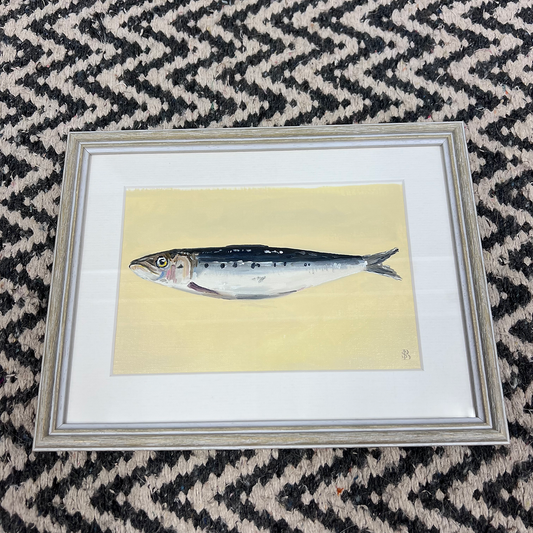 Framed illustration of a fish on a patterned fabric background