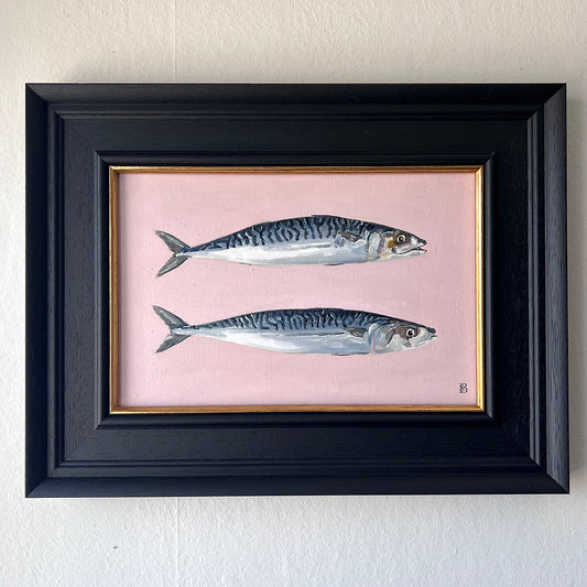 Framed artwork of two fish on a pink background