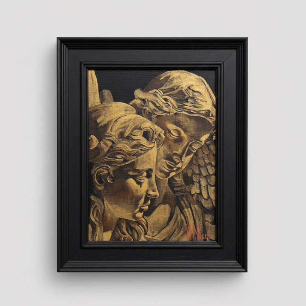 Framed artwork of classical sculpture heads on a beige wall
