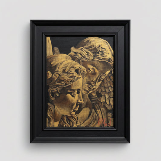 Framed artwork of classical sculpture heads on a beige wall